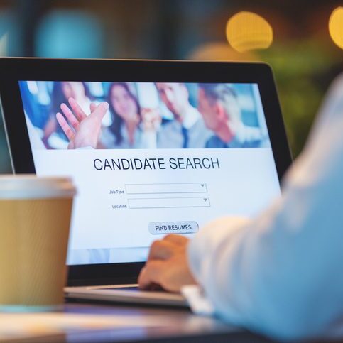 Businessman looking at recruitment website on a laptop computer. SaaS Sales Recruiter searching for candidates on computer.